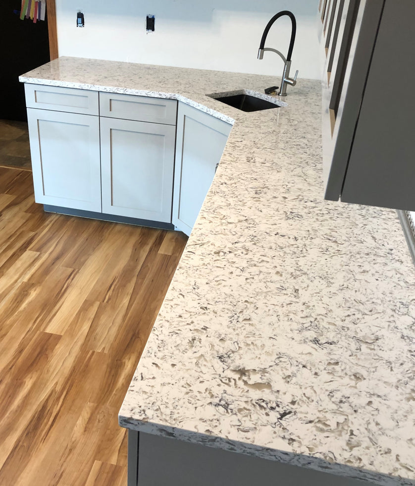 Kitchen counter with granite countertop and sink, wooden floor
