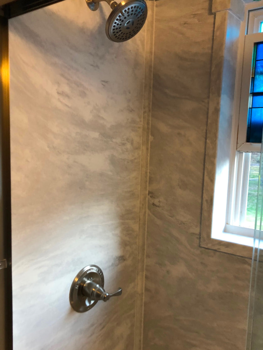 Shower with tiled walls and a window